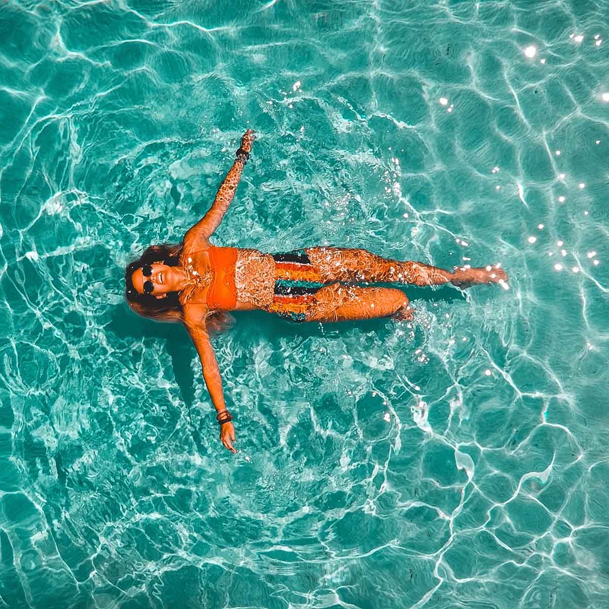 Person in bikini swimming in pool.